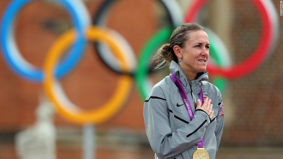 The 38-year-old mother of two, Kristin Armstrong of the United States, shows she can do it all as she celebrates during the medal ceremony after the women&#39;s individual time trial in London.