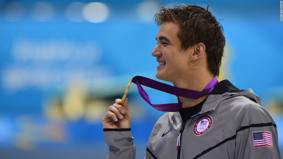 U.S. gold medalist Nathan Adrian poses on the podium after the men&#39;s 100-meter freestyle swimming event on Wednesday.