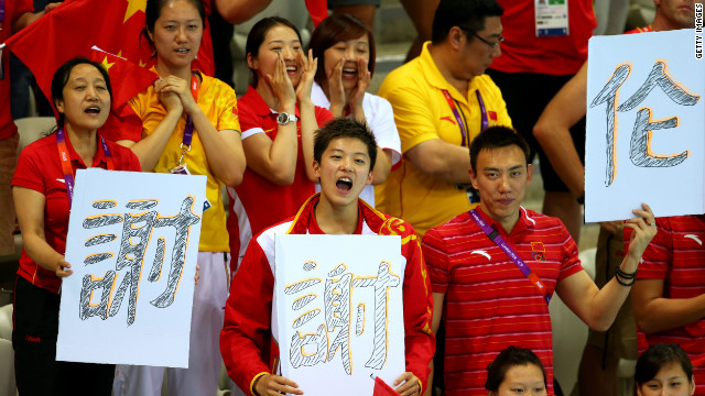 Chinese fans cheer on their athletes at the Aquatics Center at the London Olympic Games, August 1, 2012.