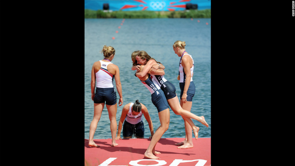 U.S. team hug after receiving their gold medals during the medal ceremony.