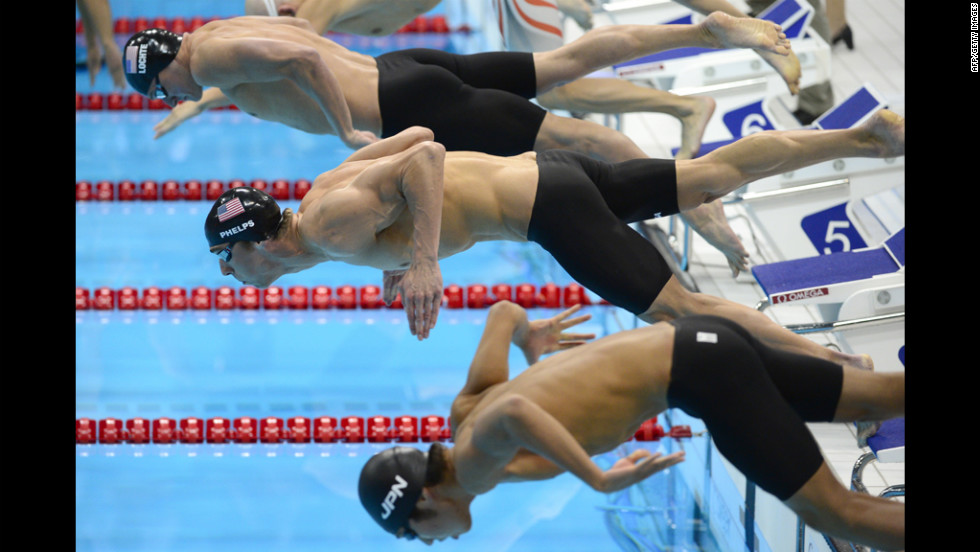 Phelps, center, dives next to U.S. swimmer Ryan Lochte, top, and Japan&#39;s Kosuke Hagino at the start of the 200-meter individual medley.