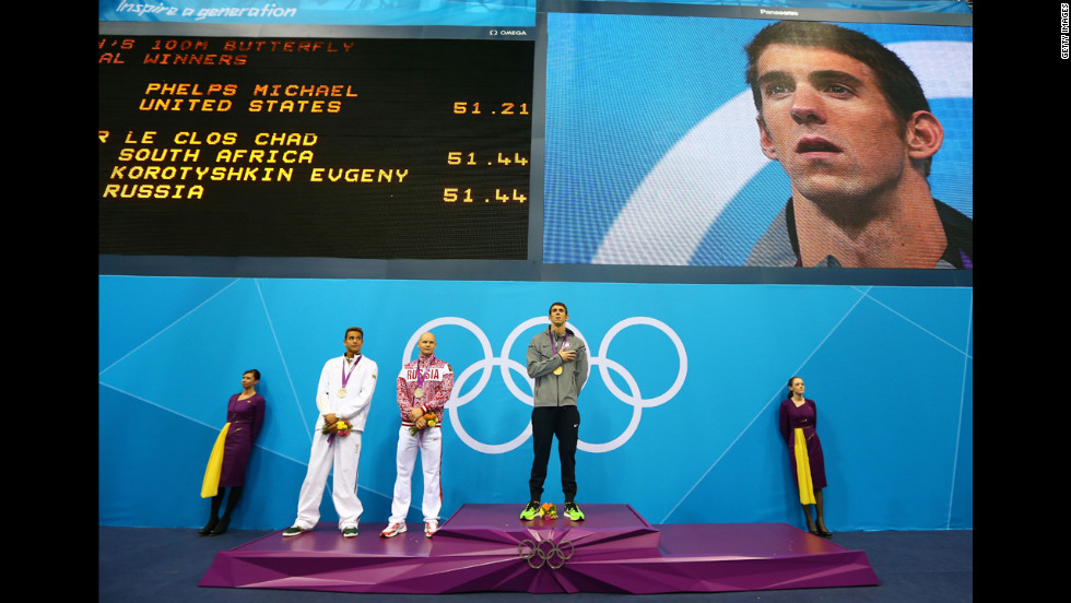 Left to right: Silver medalists Chad le Clos of South Africa and Evgeny Korotyshkin of Russia and gold medalist Michael Phelps listen to the United States national anthem during the medal ceremony for the men&#39;s 100-meter butterfly final on Friday, August 3.