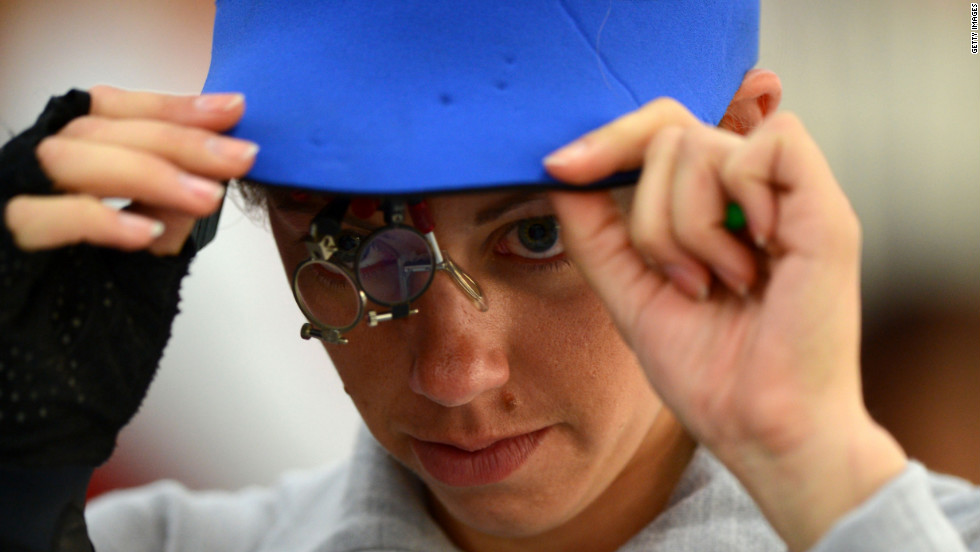 Gray adjusts her shooting equipment during the women&#39;s 50-meter rifle 3 positions shooting qualification.