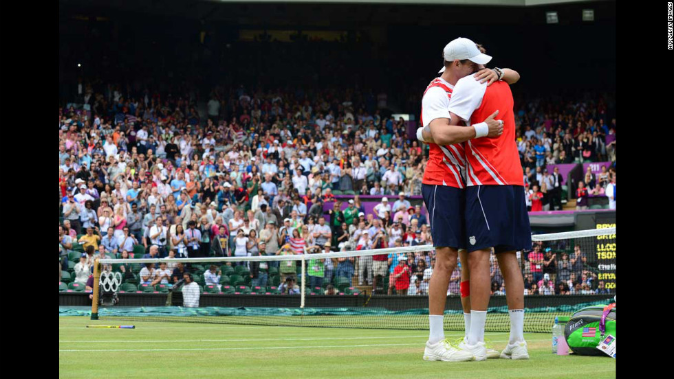 Brothers Mike Bryan, left, and Bob Bryan embrace after defeating France&#39;s Michael Llodra and Jo-Wilfried Tsonga in the men&#39;s doubles gold medal tennis match on Saturday, August 4, at Wimbledon.