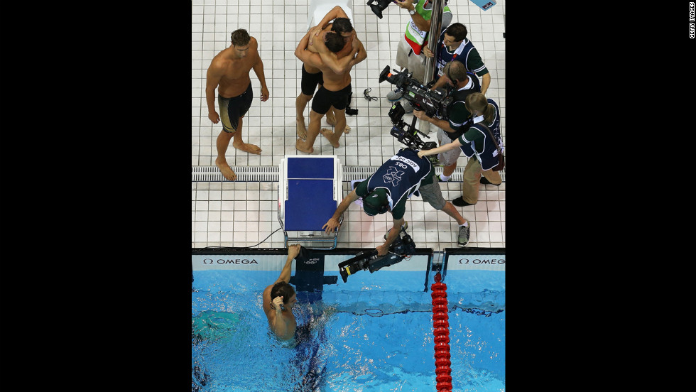 Clockwise: Matthew Grevers, Brendan Hansen, Michael Phelps and Nathan Adrian react to winning gold in the men&#39;s 4x100-meter medley relay.