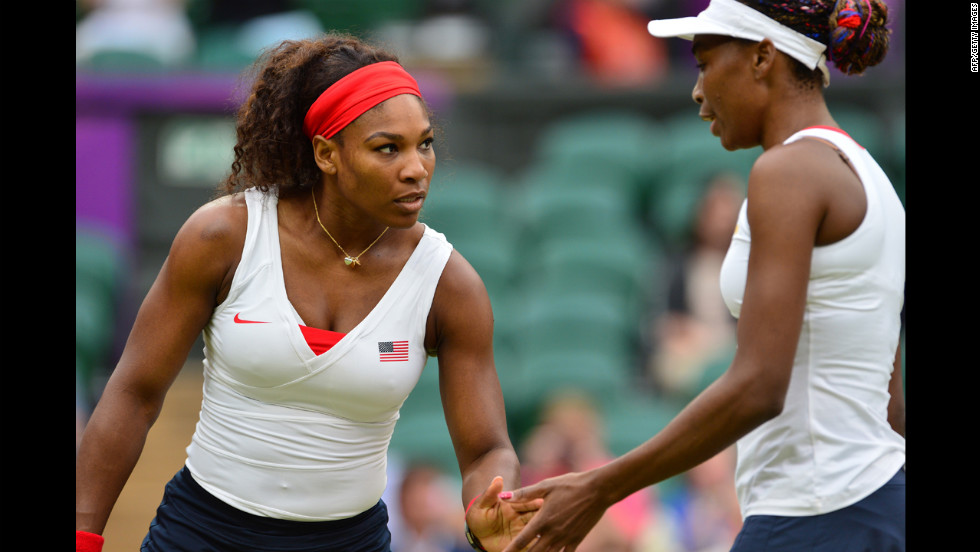 The Williams sisters talk as they play Hlavackova and Hradecka.