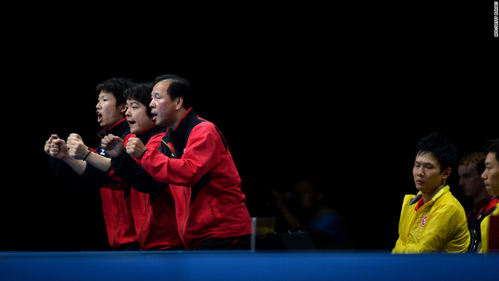 Japan&#39;s table tennis team celebrates a point for Koki Niwa against Hong Kong&#39;s Peng Tang during a men&#39;s quarterfinal match.