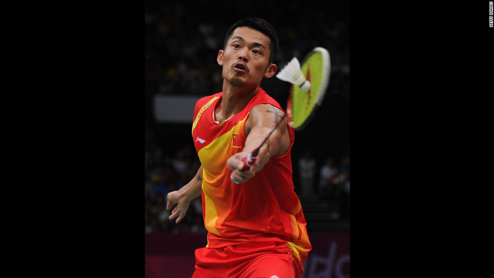 Lin Dan of China strikes the shuttlecock on his way to winning the men&#39;s singles gold medal against Chong Wei Lee of Malaysia.