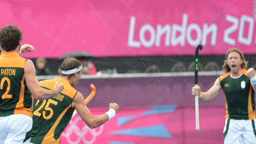 Members of the South African men&#39;s field hockey team celebrate a goal against Pakistan during a preliminary round match.