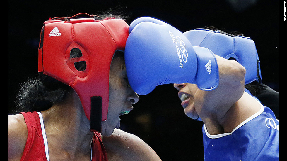 Erika Matos, left, of Brazil takes a punch from Karlha Magliocco of Venezuela in a women&#39;s flyweight boxing round of 16 match.