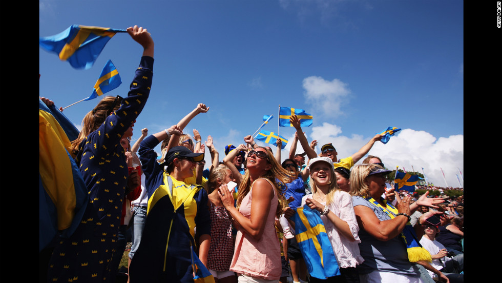 Supporters of Fredrik Loof and Max Salminen of Sweden celebrate as the sailors take overall victory following the men&#39;s star sailing medal race.