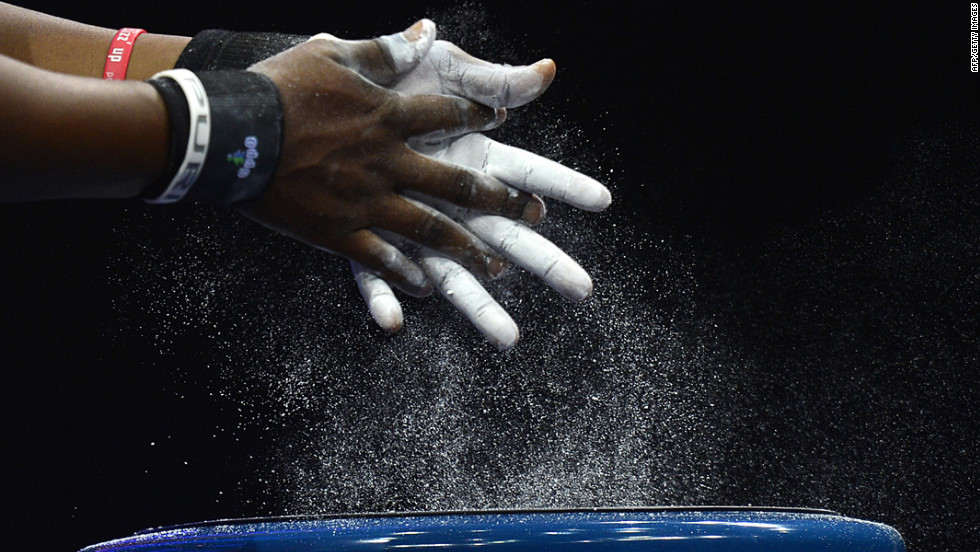 Ghana&#39;s Alberta Boatema Ampomah prepares her hands before competing in the women&#39;s 75-plus kilogram group A weightlifting event.