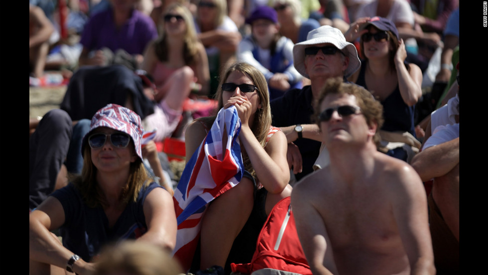 Crowds watch sailing on large screens erected on the beach in Weymouth, England. Ben Ainslie of Great Britain became the most-decorated Olympic sailor after winning an event on home waters before thousands of supporters.