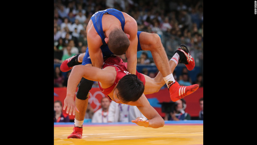 Peter Modos of Hungary, top, wrestles with Arsen Eraliev of Kyrgyzstan, bottom, during the men&#39;s Greco-Roman 55-kilogram wrestling qualification.