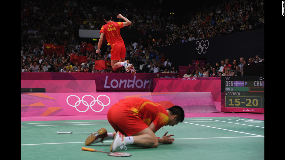 Yun Cai and Haifeng Fu of China revel in their victory against Mathias Boe and Carsten Mogensen of Denmark in the men&#39;s doubles badminton gold medal match.