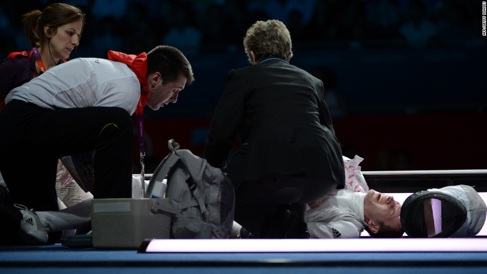 Germany&#39;s Sebastian Bachmann is treated by medical personnel after being injured during his bout with U.S. fencer Gerek Meinhardt during the men&#39;s foil team medal bronze match.