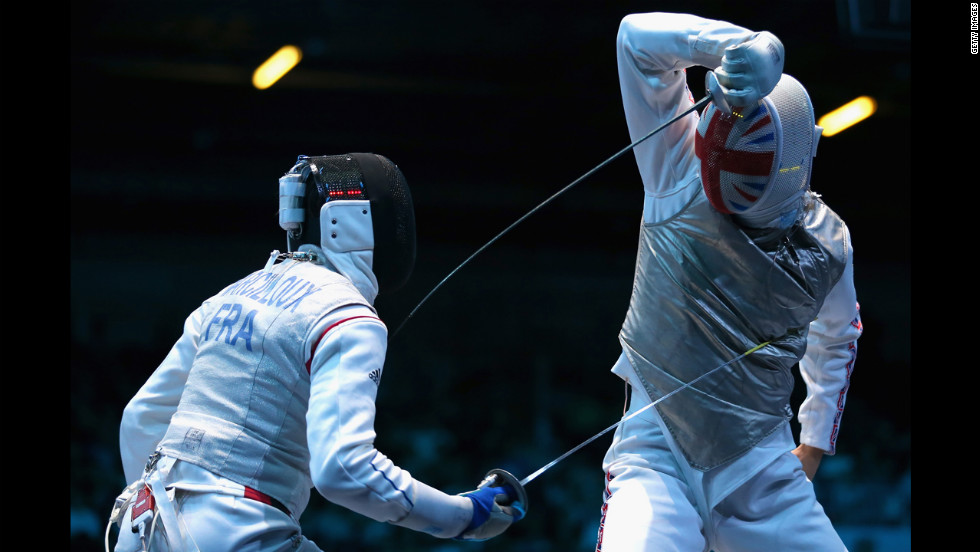 Marcel Marcilloux of France strikes Richard Kruse of Great Britain during the men&#39;s foil team fencing match.