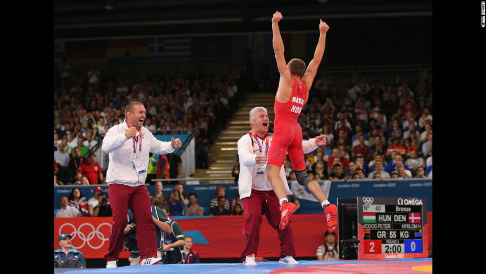 Peter Modos of Hungary jumps for joy after winning the men&#39;s Greco-Roman 55-kilogram wrestling bronze medal bout against Haakan Erik Nyblom of Denmark.