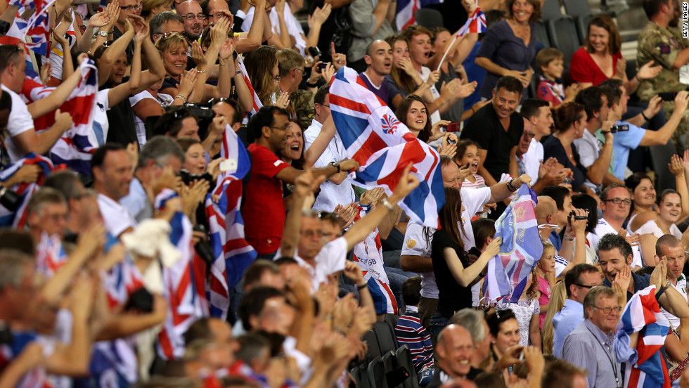 Spectators cheer from the stands during track cycling events at London Velopark in east London.