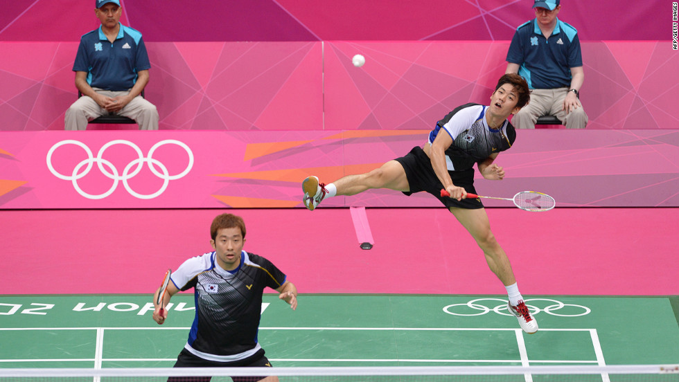 South Korea&#39;s Lee Yong Dae, right, plays a return next to his partner, Chung Jae Sung, in the bronze medal men&#39;s doubles badminton match against Koo Kien Keat and Tan Boon Heong of Malaysia.