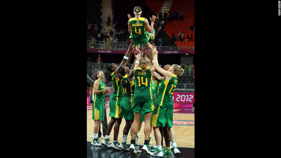 No. 4 Adriana Pinto is thrown into the air by teammates to honor her final game with the Brazil National Team after the women&#39;s basketball preliminary round match against Great Britain.