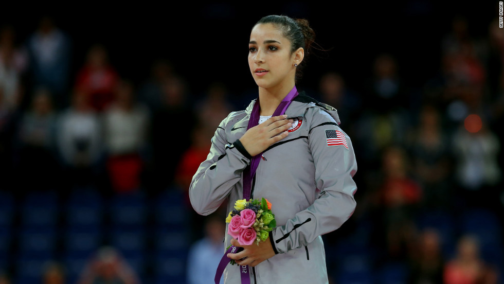 Gold medalist Alexandra Raisman poses on the podium during the medal ceremony for the women&#39;s gymnastics floor exercise final on Tuesday.