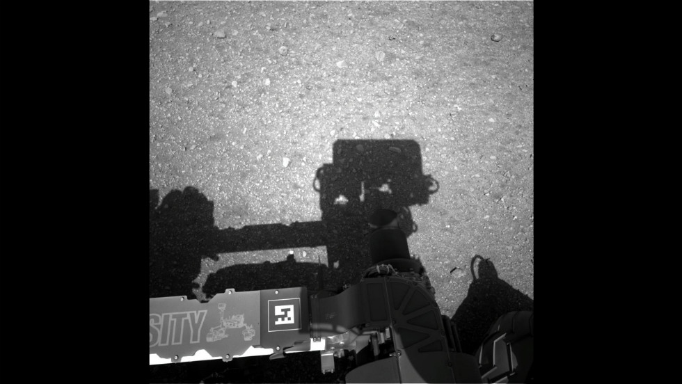 This first image taken by the Navigation cameras on Curiosity shows the rover&#39;s shadow on the surface of Mars.