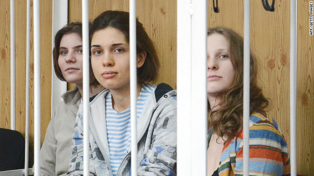 Members of female punk band &#39;Pussy Riot&#39; sit behind the bars during a court hearing in Moscow on July 20, 2012.