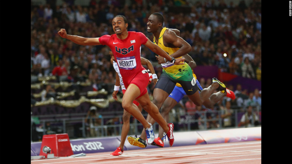 Aries Merritt of the United States crosses the finish line ahead of Hansle Parchment of Jamaica to win gold in the men&#39;s 110-meter hurdles final.