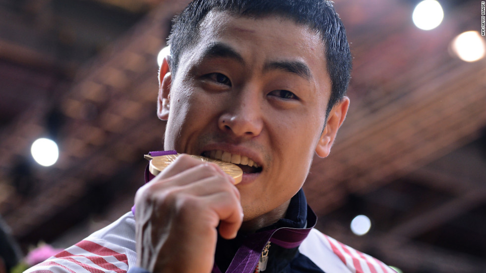 South Korea&#39;s Song Dae-nam bites his gold medal after winning a judo event.