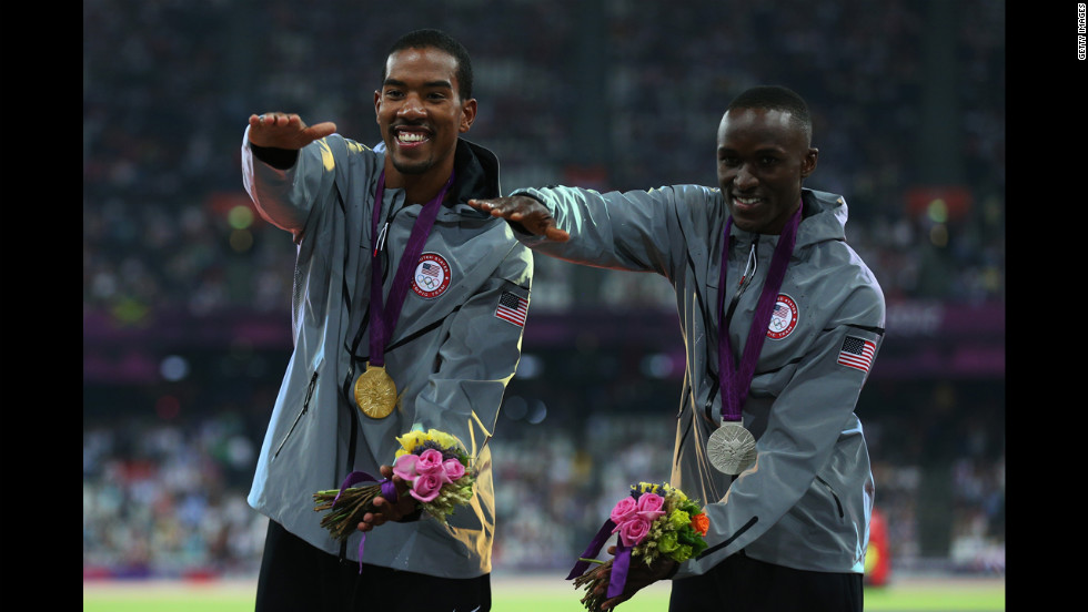 Gold medalist Christian Taylor and silver medalist Will Claye, also of the United States, celebrate during the medal ceremony for the men&#39;s triple jump. Both athletes attended the University of Florida and are seen doing the &quot;Gator chomp.&quot;