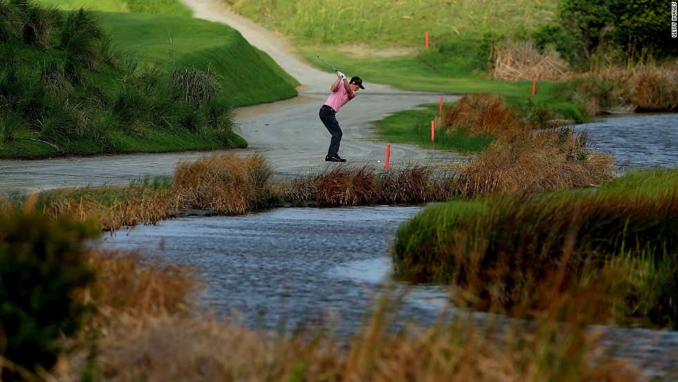 Luke Donald of England hits a shot on the 2nd hole.