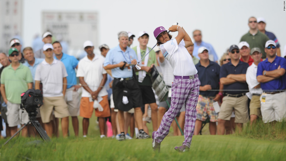 Rickie Fowler punches a ball on the 17th hole on Friday.