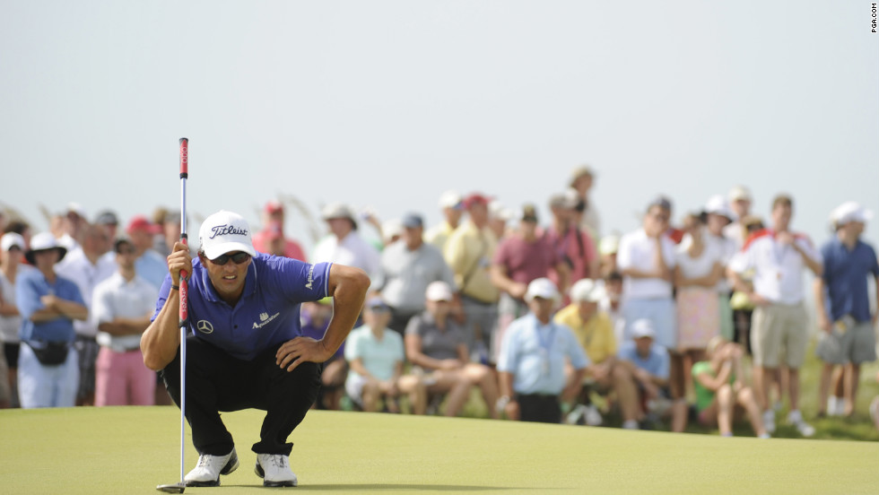 Adam Scott studies the green on the 16th hole.