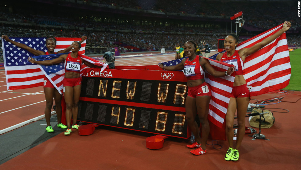 Carmelita Jeter, Bianca Knight, Allyson Felix and Tianna Madison of the United States celebrate next to the clock after winning gold and setting a new world record of 40.82 seconds in the women&#39;s 4x100m relay final.