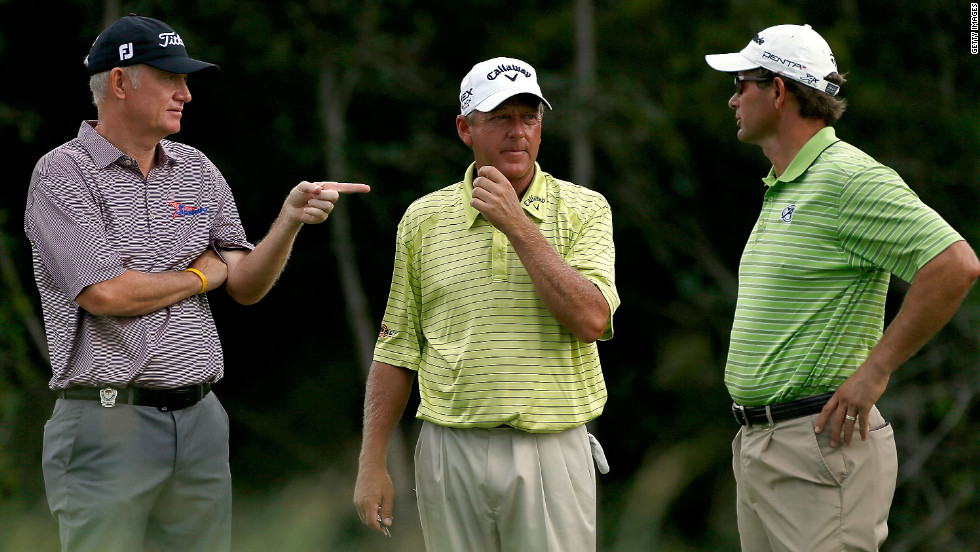 England&#39;s Roger Chapman, from left, Mark Brooks of the United States and South Africa&#39;s Retief Goosen talk on the 2nd tee.