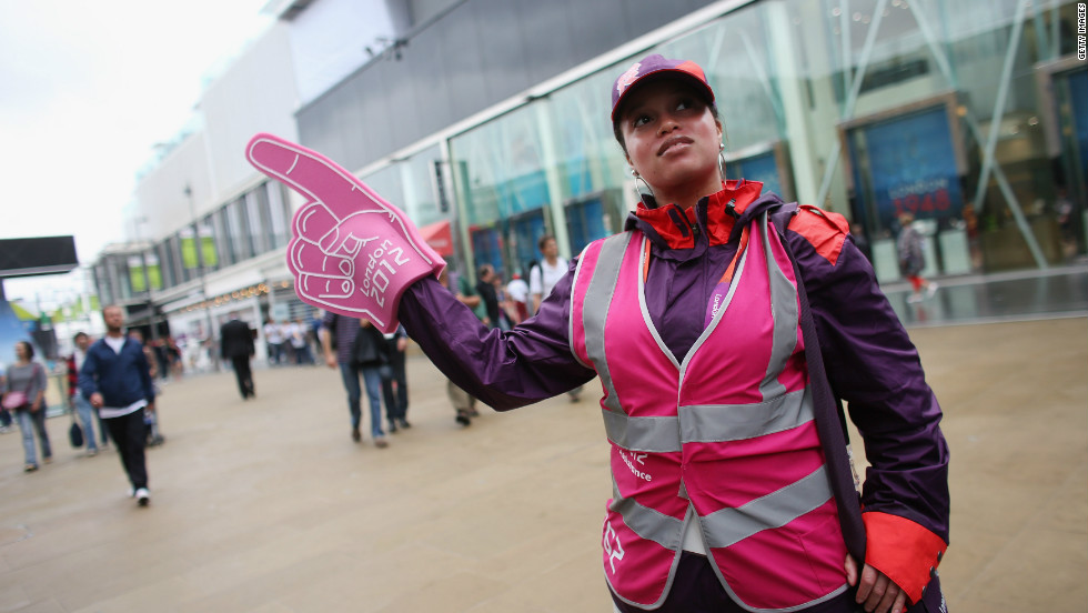 An army of volunteers clad in bright purple, red and pink welcome visitors to the Games.