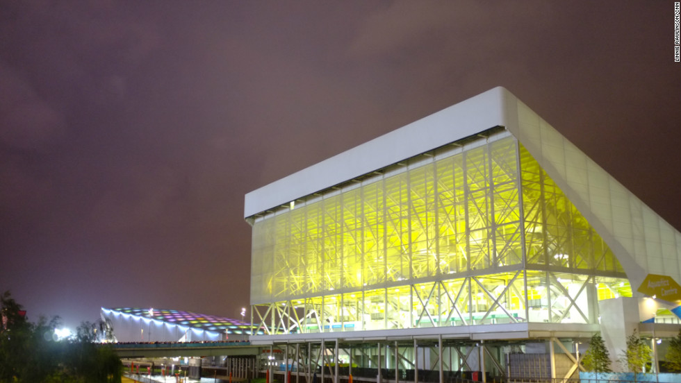 The Aquatic Centre with the Water Polo Arena in the background. From this angle, the Arena almost looked like a blue whale rising up from the Lea. The lights in its roof pulsed from blue to green to purple. 