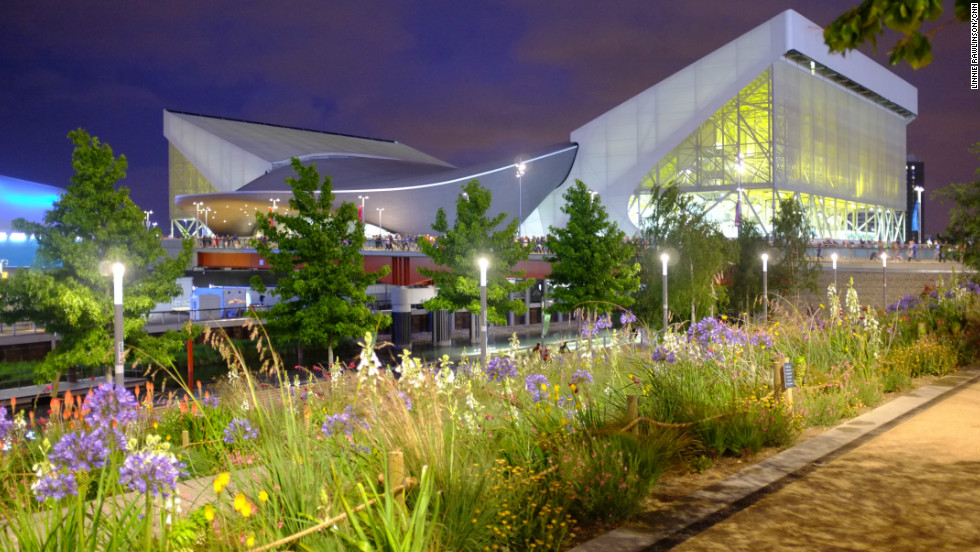 The Aquatic Centre shone neon yellow beyond wildflower planting on the banks of the River Lea. The venue&#39;s curved center, designed by architect Zaha Hadid, will remain after the Games. The sweeping wings either side are temporary stands that will be dismantled at the end of the Games. 