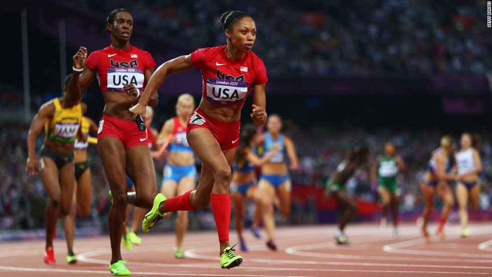 Allyson Felix receives the relay baton from DeeDee Trotter during the women&#39;s 4x400-meter relay final. 