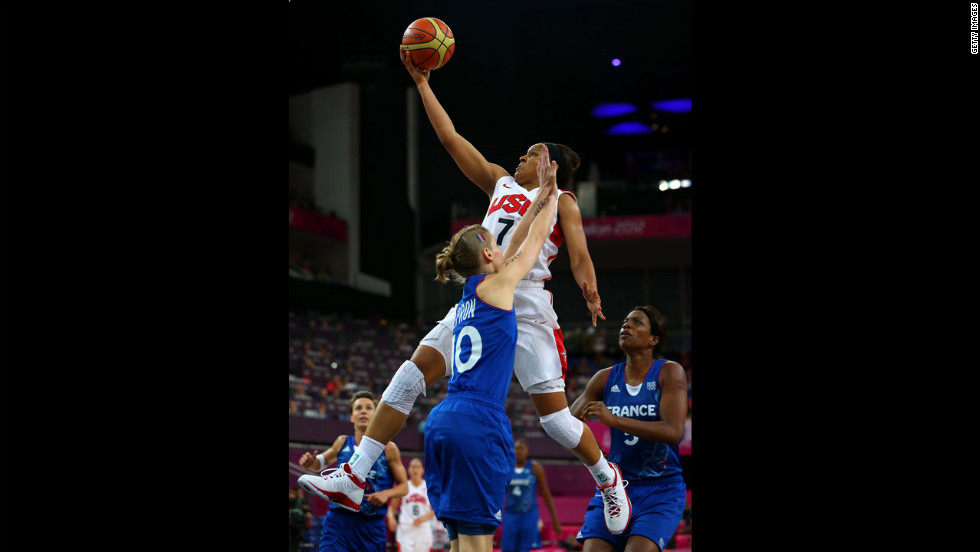 Maya Moore, in white, leaps for the basket against France&#39;s Florence Lepron in the second half.