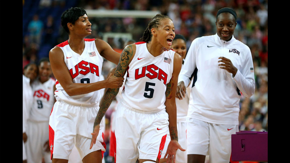 Seimone Augustus (#5) and Angel McCoughtry (#8) celebrate with the rest of the U.S. women&#39;s basketball team after defeating France 86-50 to win the gold medal at London 2012. 