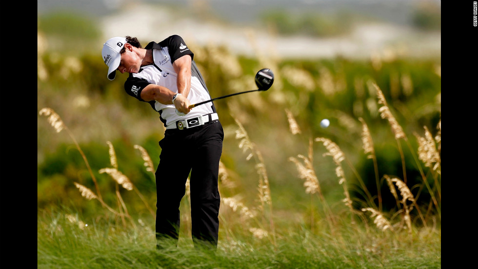 Rory McIlroy of Northern Ireland, who goes into Sunday&#39;s play in the lead at 6 under par, hits off the sixth tee.