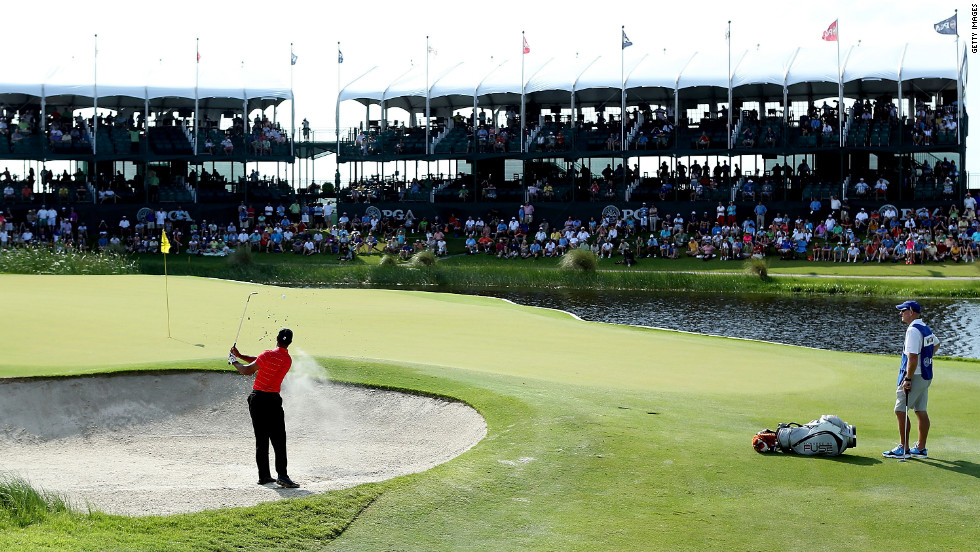 Tiger Woods hits out of the sand on the 17th hole during the third round.