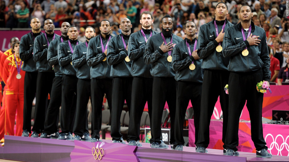 With hands over their hearts, the U.S. team listens as &quot;The Star Spangled Banner&quot; is played after the team was awarded their gold medals.