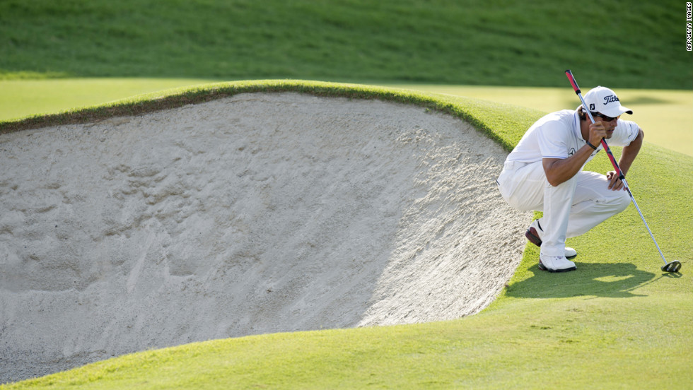 Adam Scott of Australia lines up a putt during round three. Play in the third round resumed Sunday after it was suspended late Saturday due to bad weather.