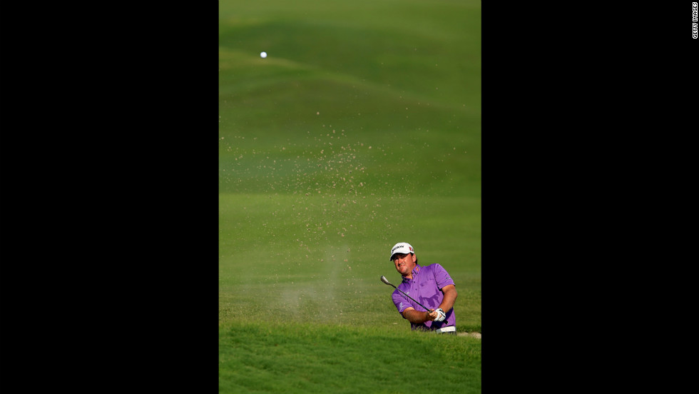 Graeme McDowell of Northern Ireland hits out of a bunker on the 18th hole during round three.