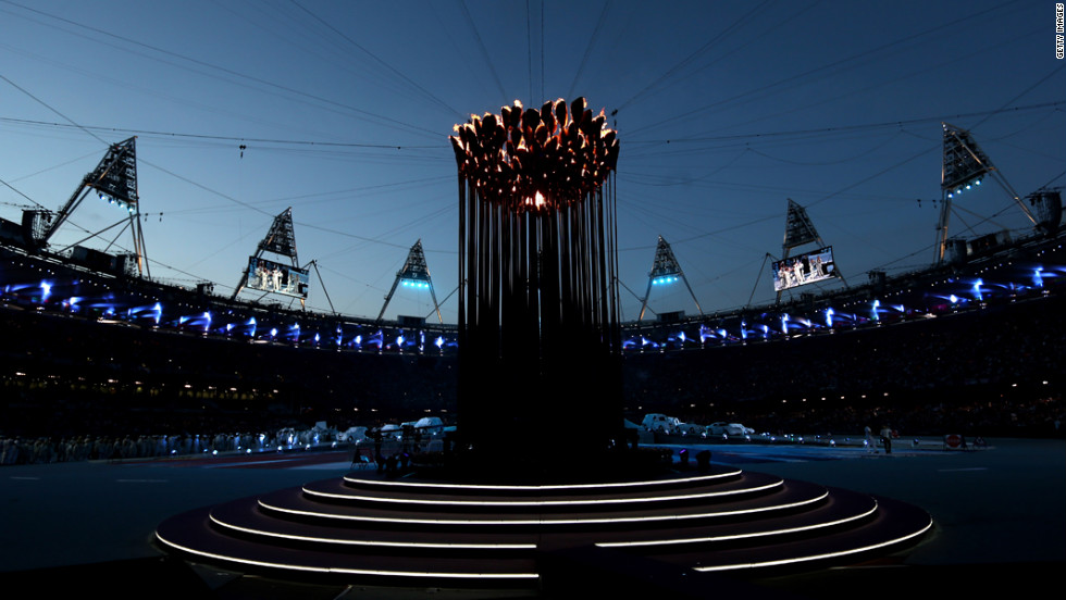 The Olympic Cauldron burns at the center of the stadium.