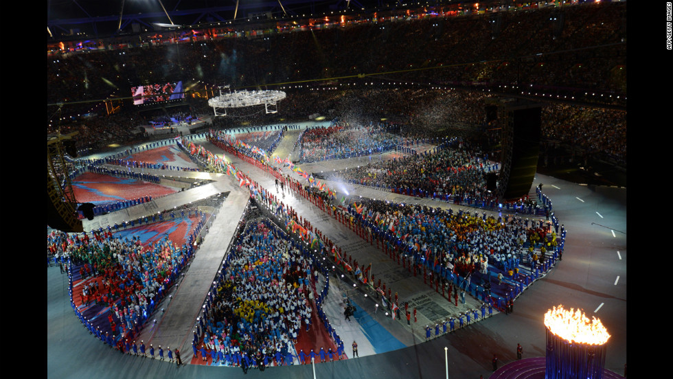 Athletes form a living Union Jack on the floor of Olympic stadium.