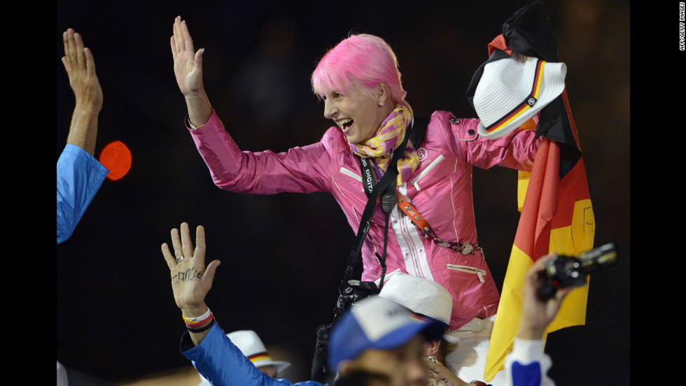 An athlete waves a German flag during the athletes&#39; parade at the Olympic stadium.